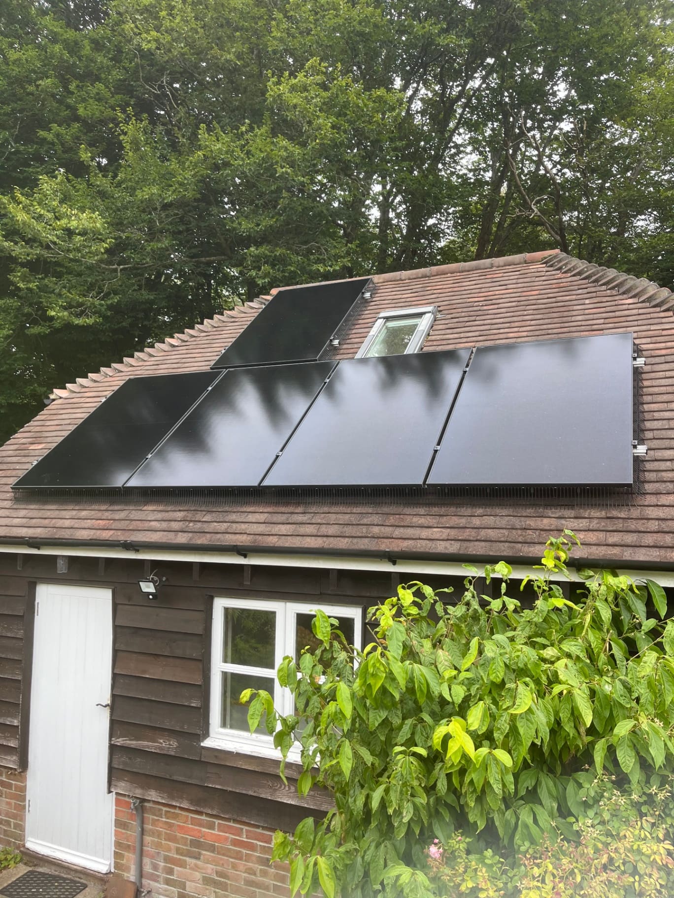 Black solar PV panels installed on a tiled roof