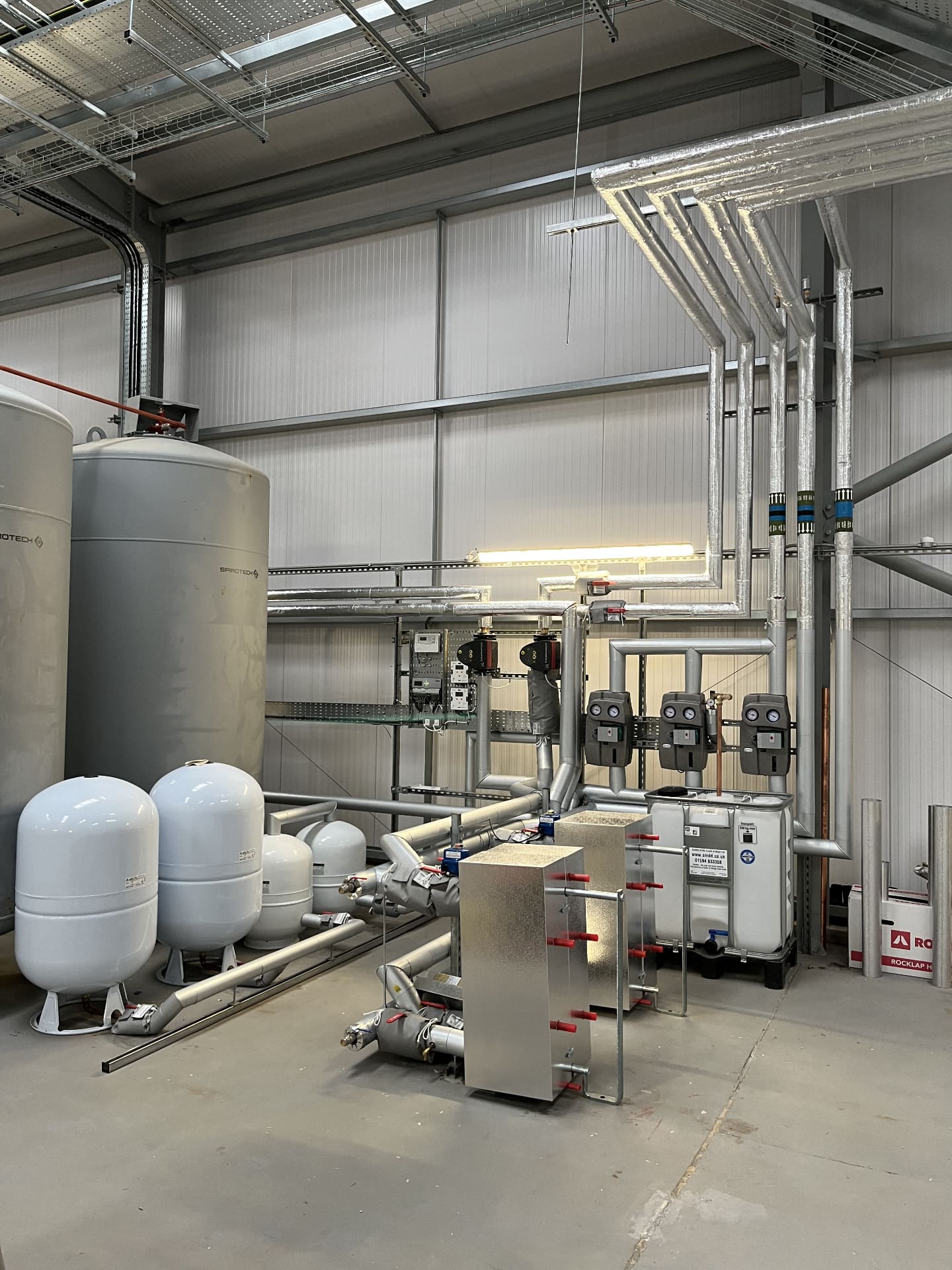 Solar thermal plant room with vessels, pumps and heat exchanger